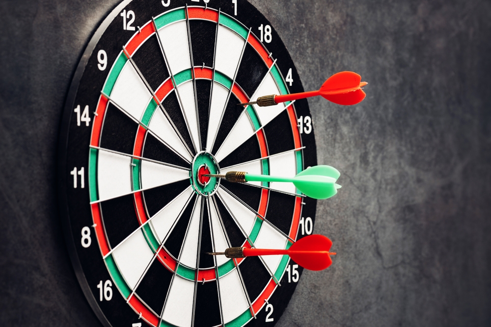 a,close up,image,of,a,dartboard,featuring,three,darts,lodged