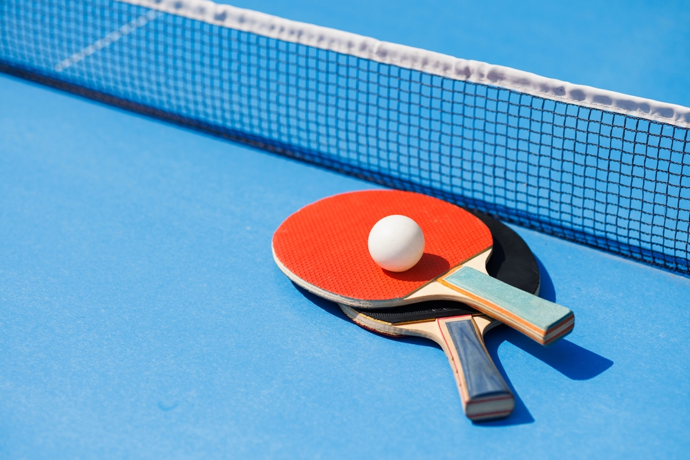 tennis,rackets,for,playing,ping,pong,on,blue,table,,ping